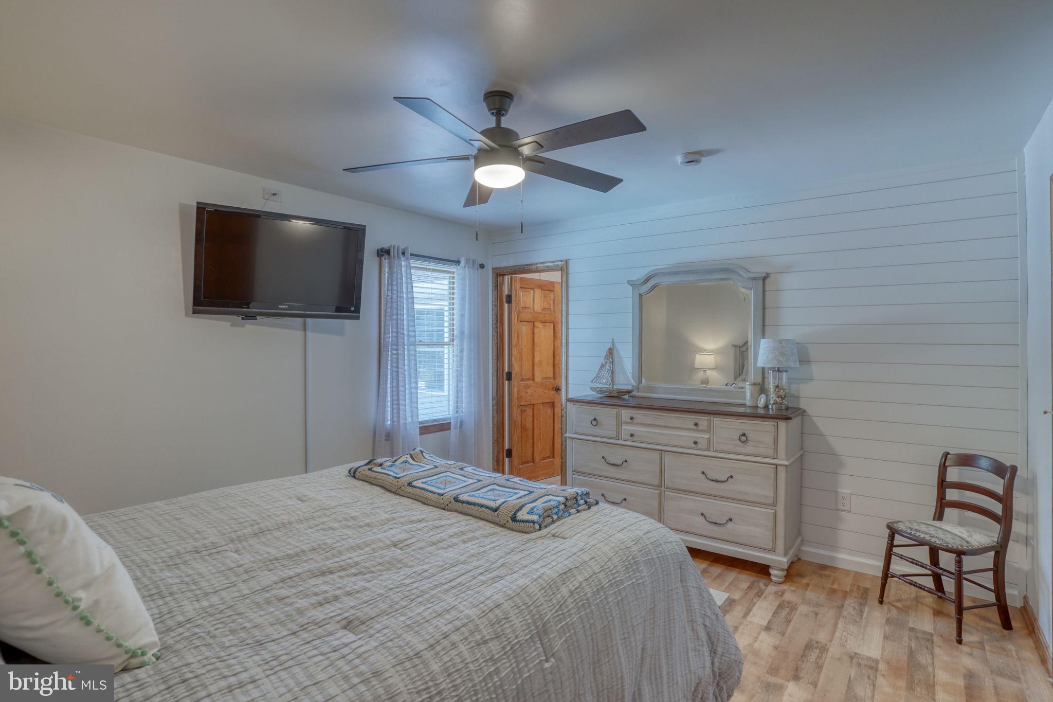 6420 Pearsons Corner Road Dover, DE 19904 - Photo 29 of 54 a bedroom with a bed and a flat screen tv