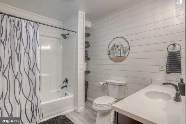 a spacious bedroom with a bed and a painting on the wall