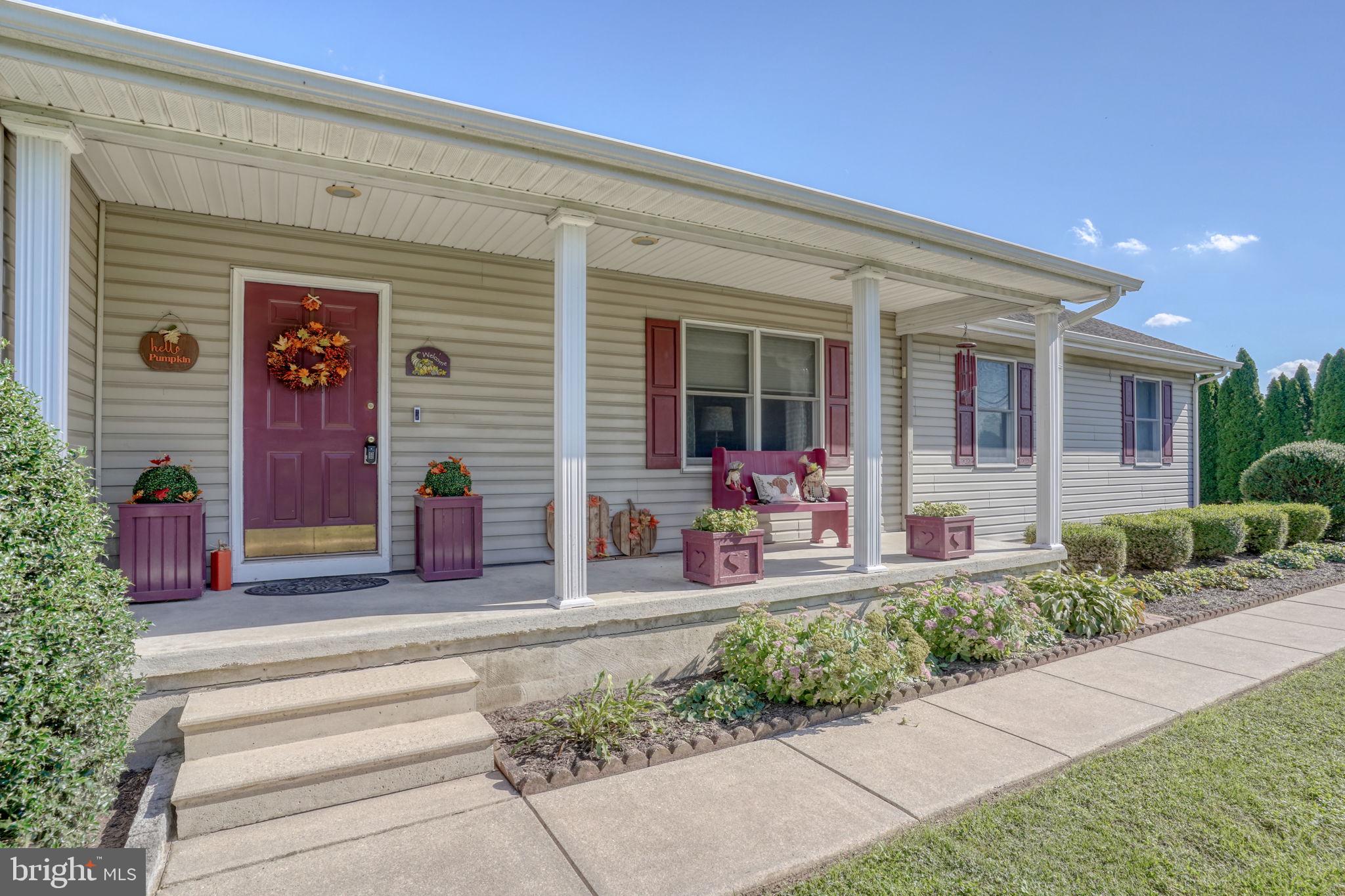 6420 Pearsons Corner Road Dover, DE 19904 - Photo 3 of 54 a front view of a house with sitting area and garden