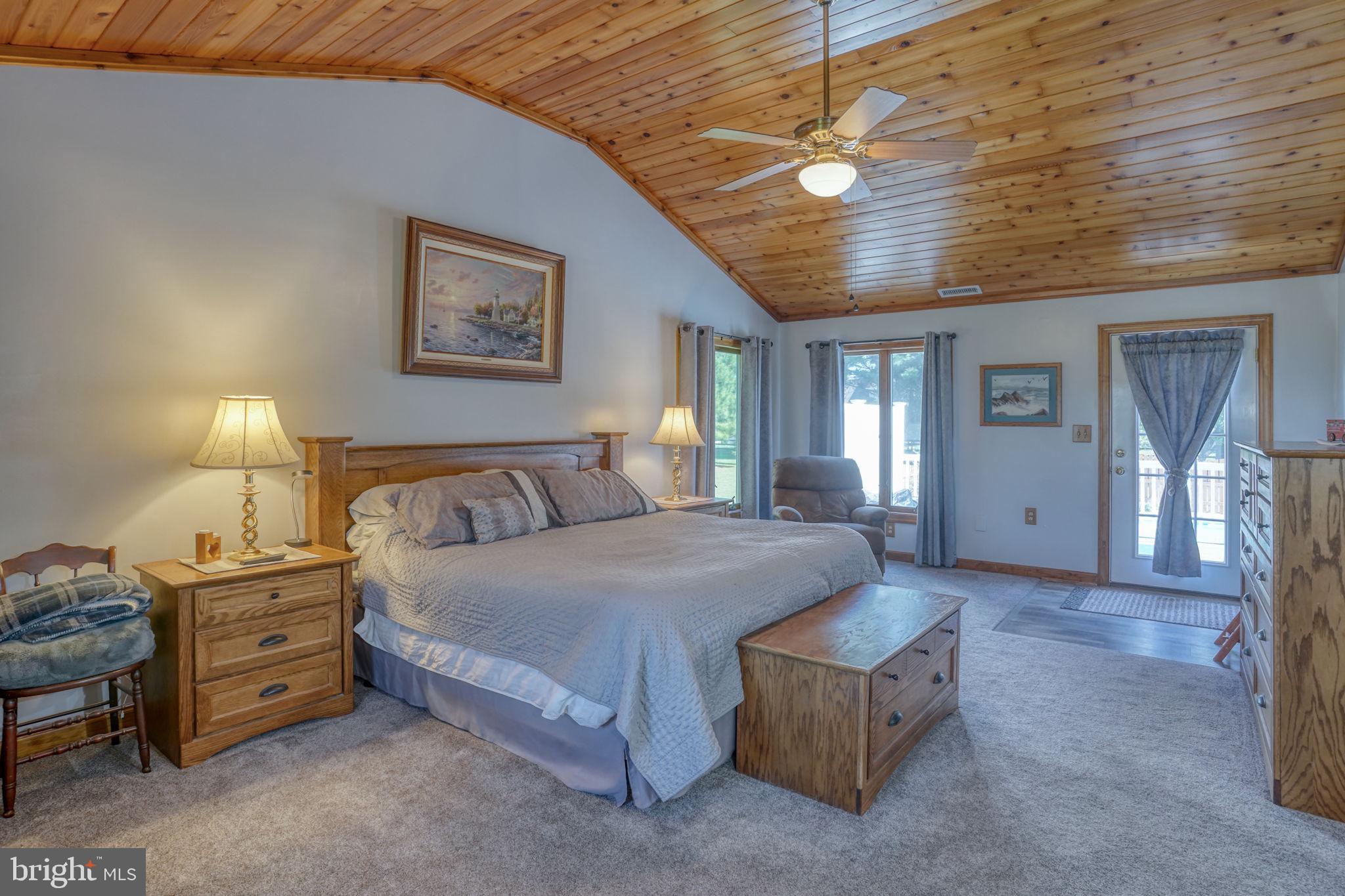 6420 Pearsons Corner Road Dover, DE 19904 - Photo 35 of 54 a spacious bedroom with a bed a lamp and window