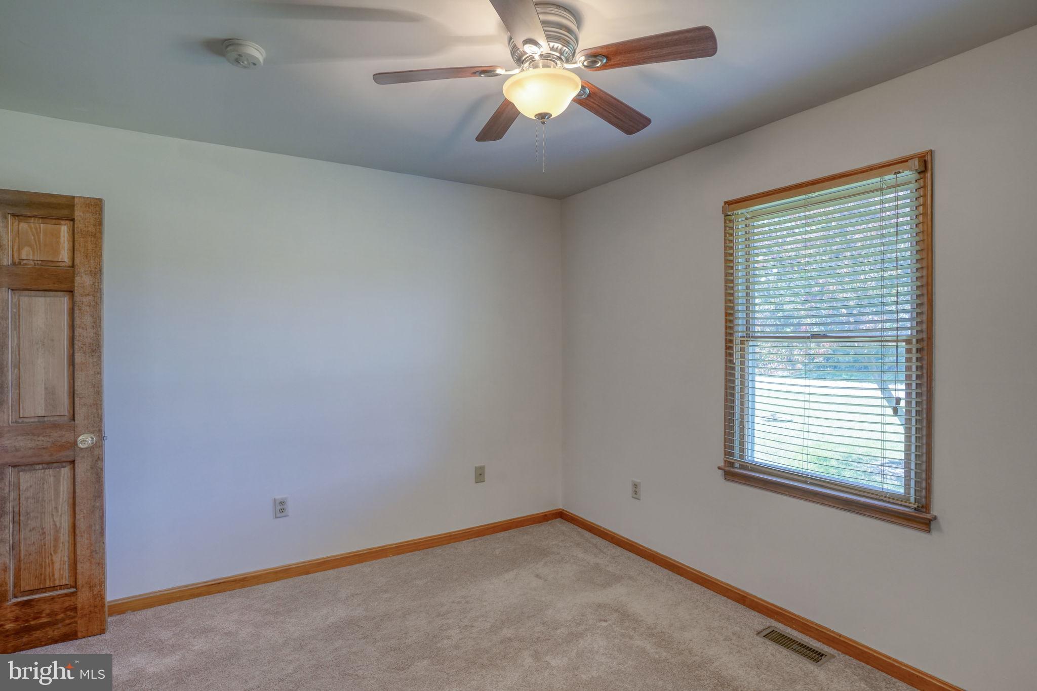 6420 Pearsons Corner Road Dover, DE 19904 - Photo 40 of 54 an empty room with windows and fan