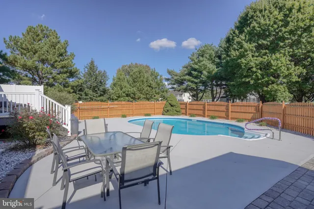 a view of a house with swimming pool and a chairs