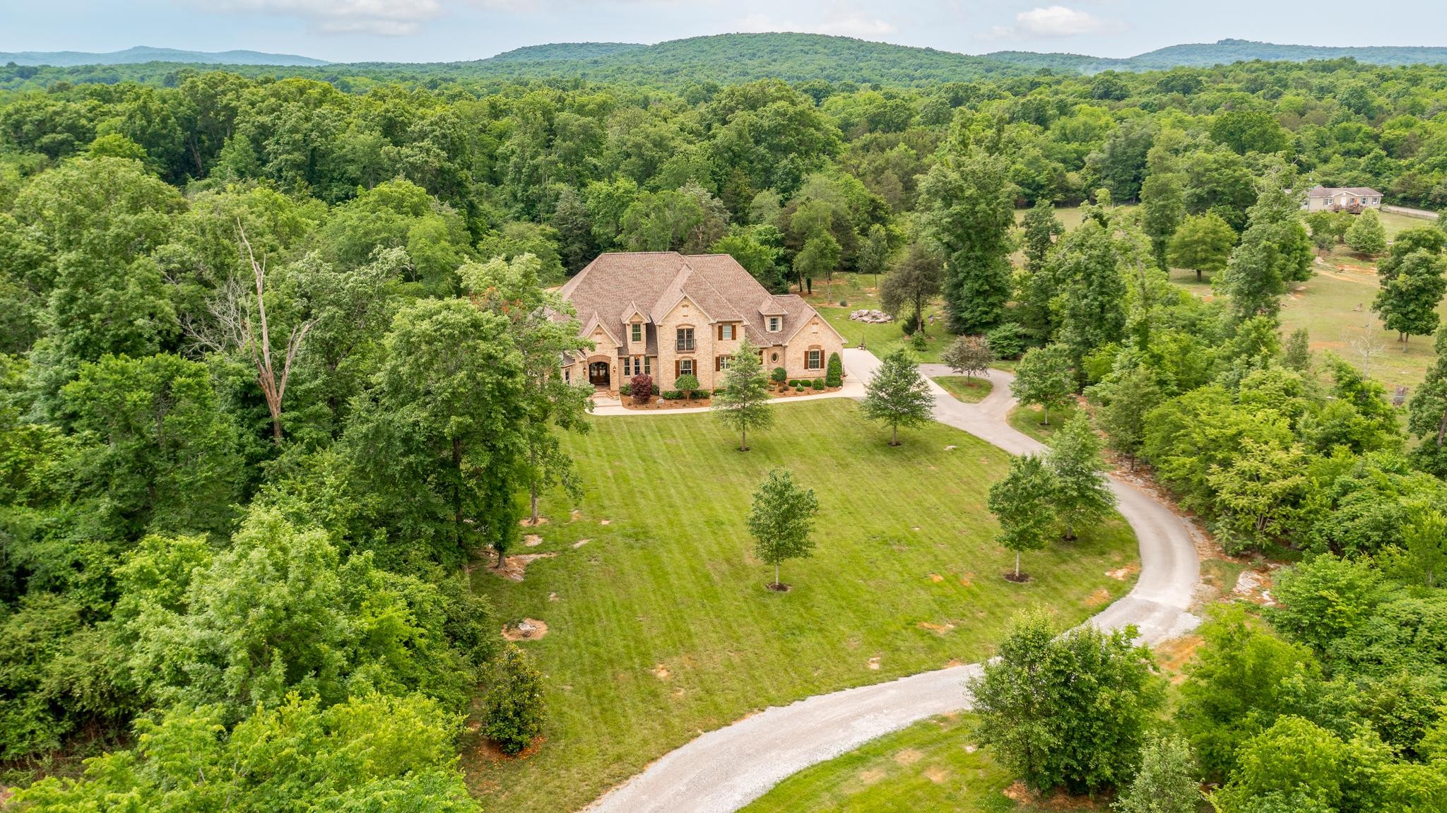 6201 Windrow Road Rockvale, TN 37153 - Photo 42 of 49 a view of a lake with a house in the background