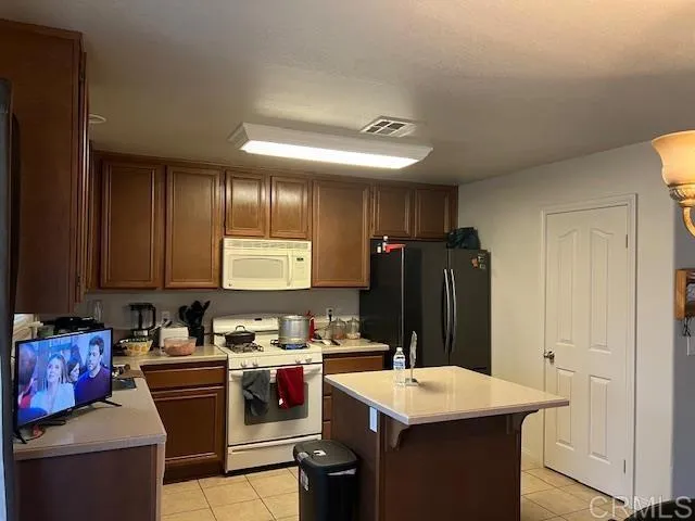a kitchen with a sink stove and refrigerator
