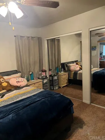 a bedroom with a bed window and couch