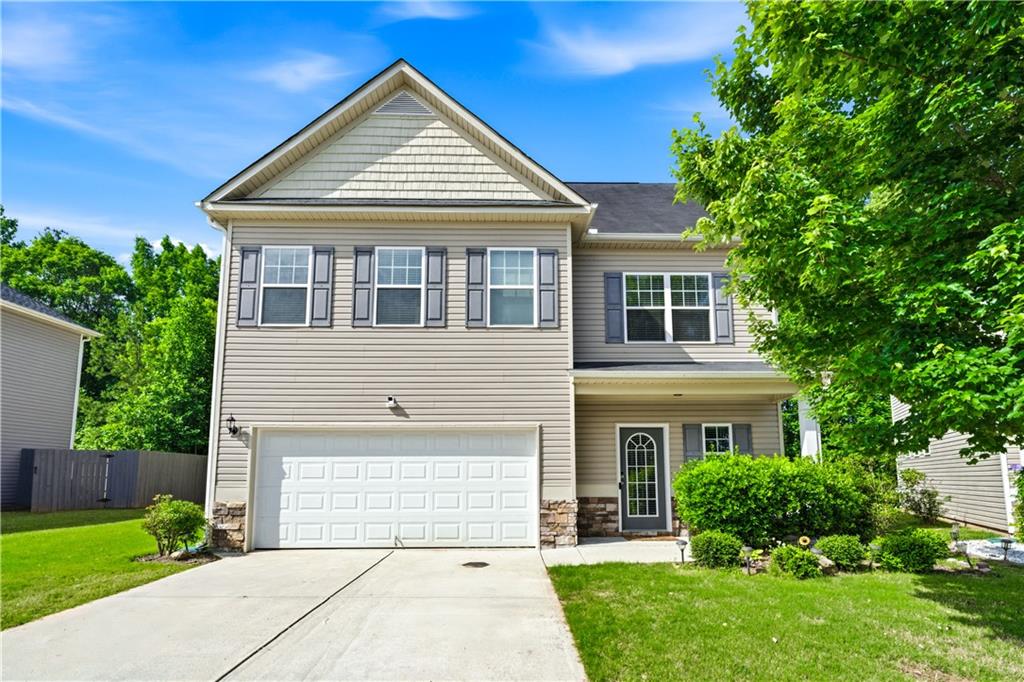 291 Boulder Run Hiram, GA 30141 - Photo 2 of 46 a front view of a house with a yard and trees