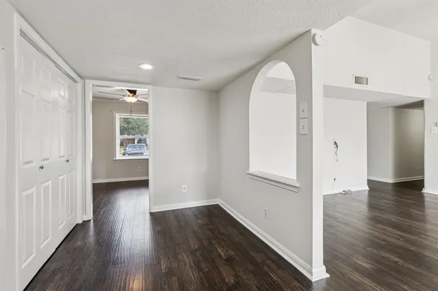 wooden floor in an empty room with a window