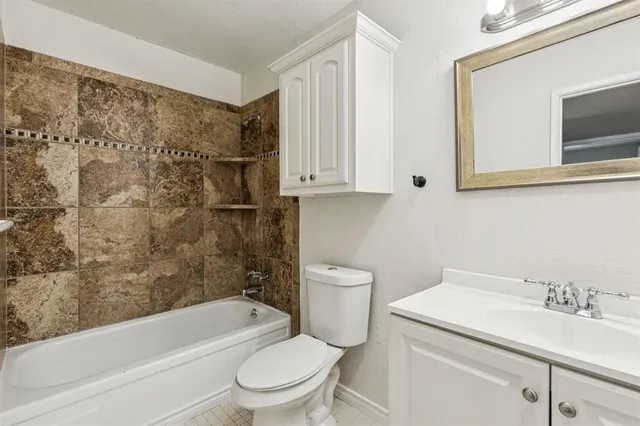 a bathroom with a sink a toilet and bathtub