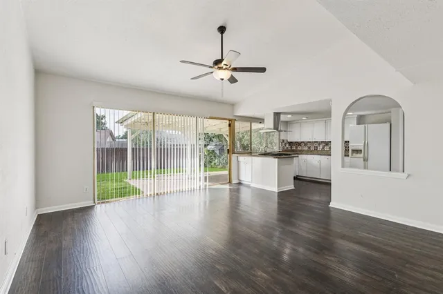 a view of kitchen with wooden floor electronic appliances and windows