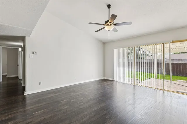 a view of a room with wooden floor and windows