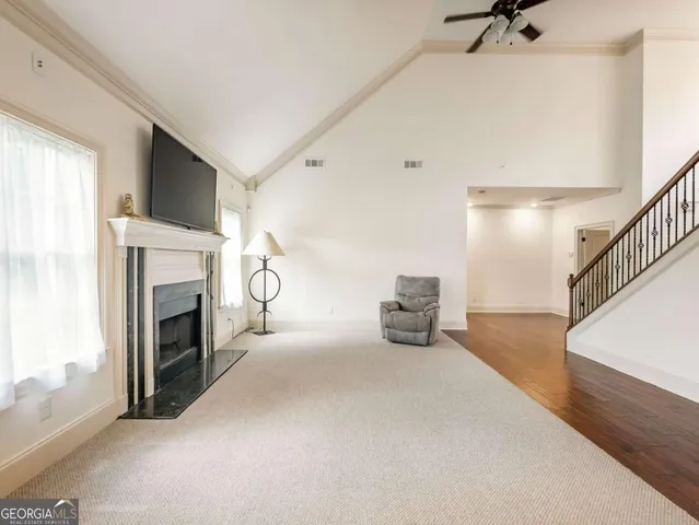 a view of an empty room with fireplace and a window