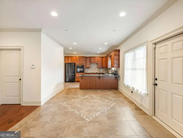a open kitchen with stainless steel appliances kitchen island a refrigerator sink and cabinets