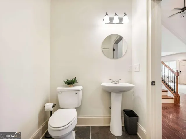 a bathroom with a toilet a sink and mirror