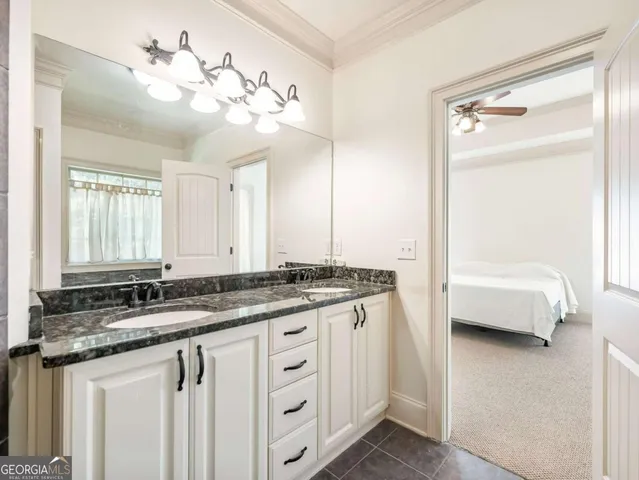 a bathroom with a granite countertop sink a large mirror and a