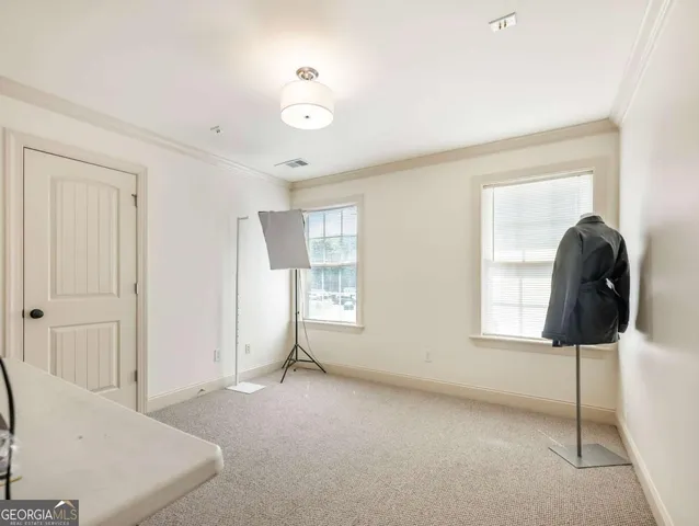 a view of a livingroom with window and hardwood floor