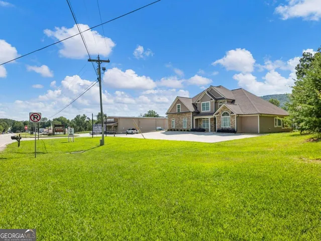 a view of a house with a backyard and pool