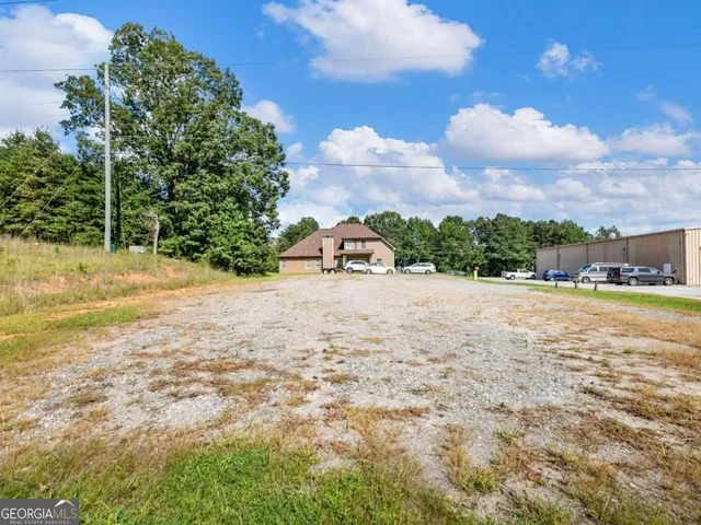 a view of yard with swimming pool and trees