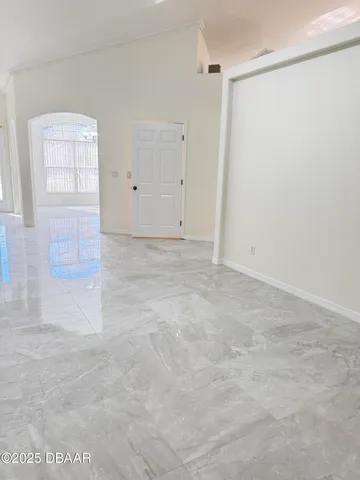 an empty room with windows and closet