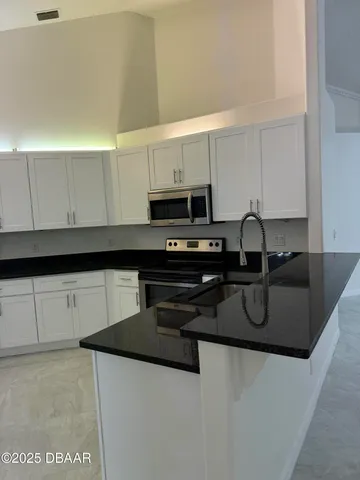 a kitchen with a refrigerator and a sink