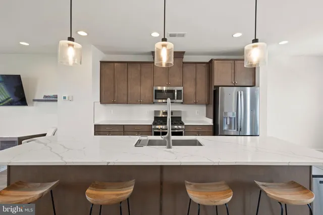 a kitchen with a table chairs sink and microwave