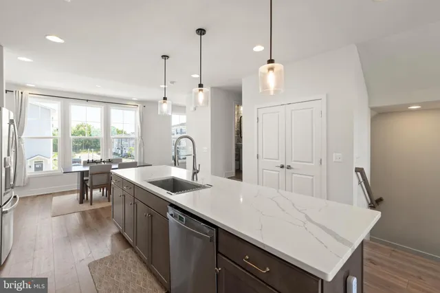 a kitchen with a sink a counter space and a dining table
