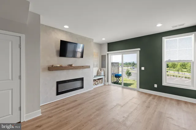 a view of a livingroom with a fireplace a window and a fireplace