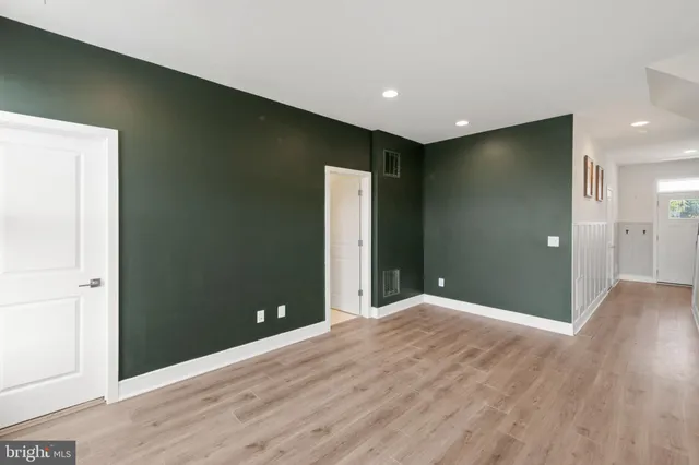 a view of an empty room with wooden floor
