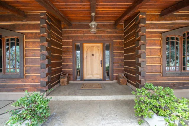 a bedroom with a bed and dresser with wooden floor
