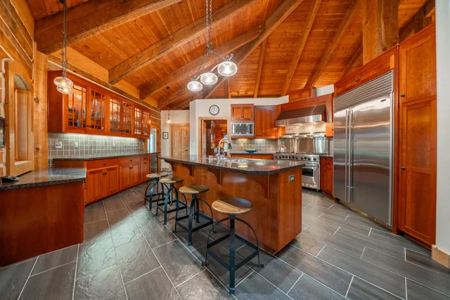 a view of a house with a small yard and potted plants