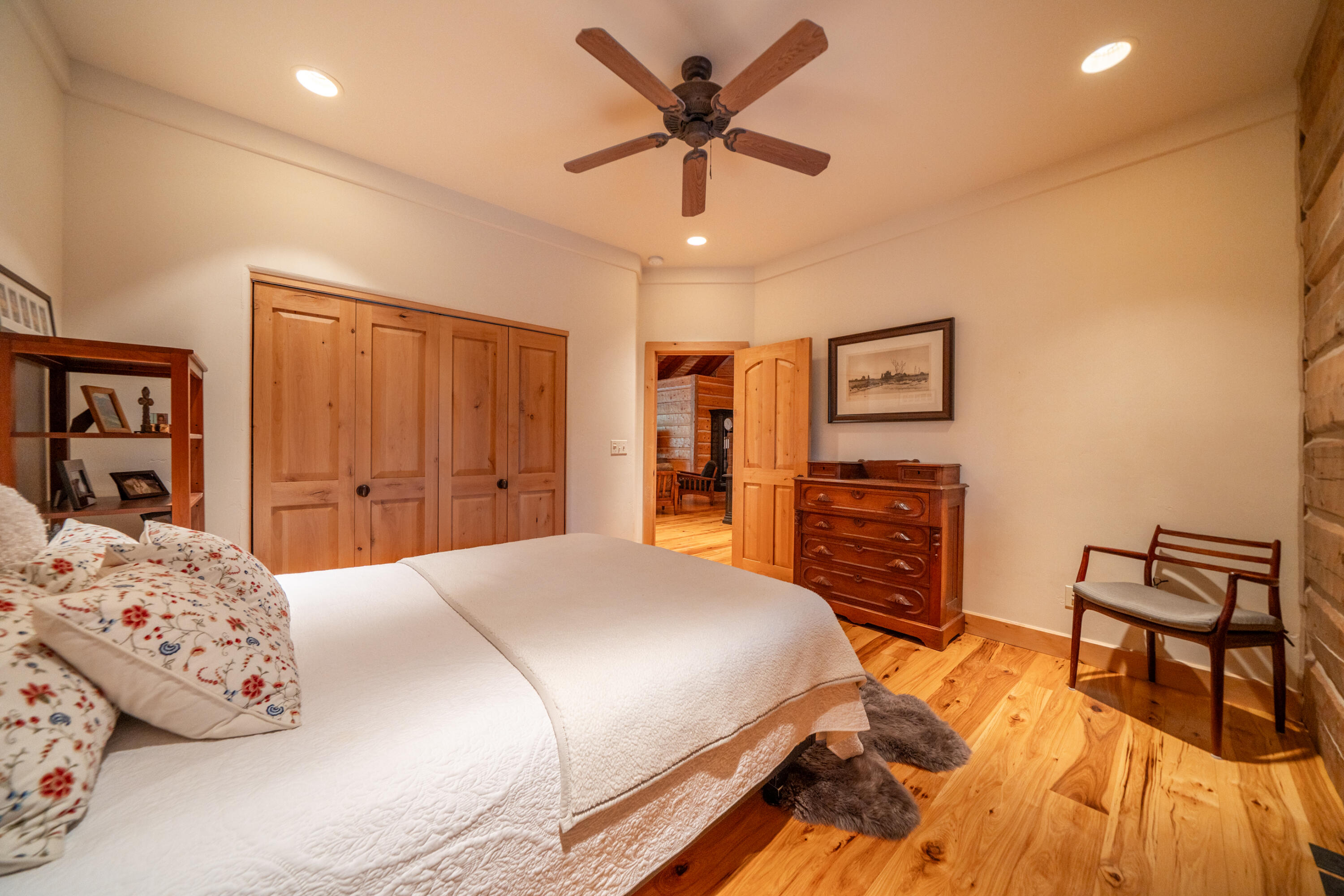 15900 El Camino Robles Road Redding, CA 96001 - Photo 42 of 116 a bedroom with a bed and dresser with wooden floor