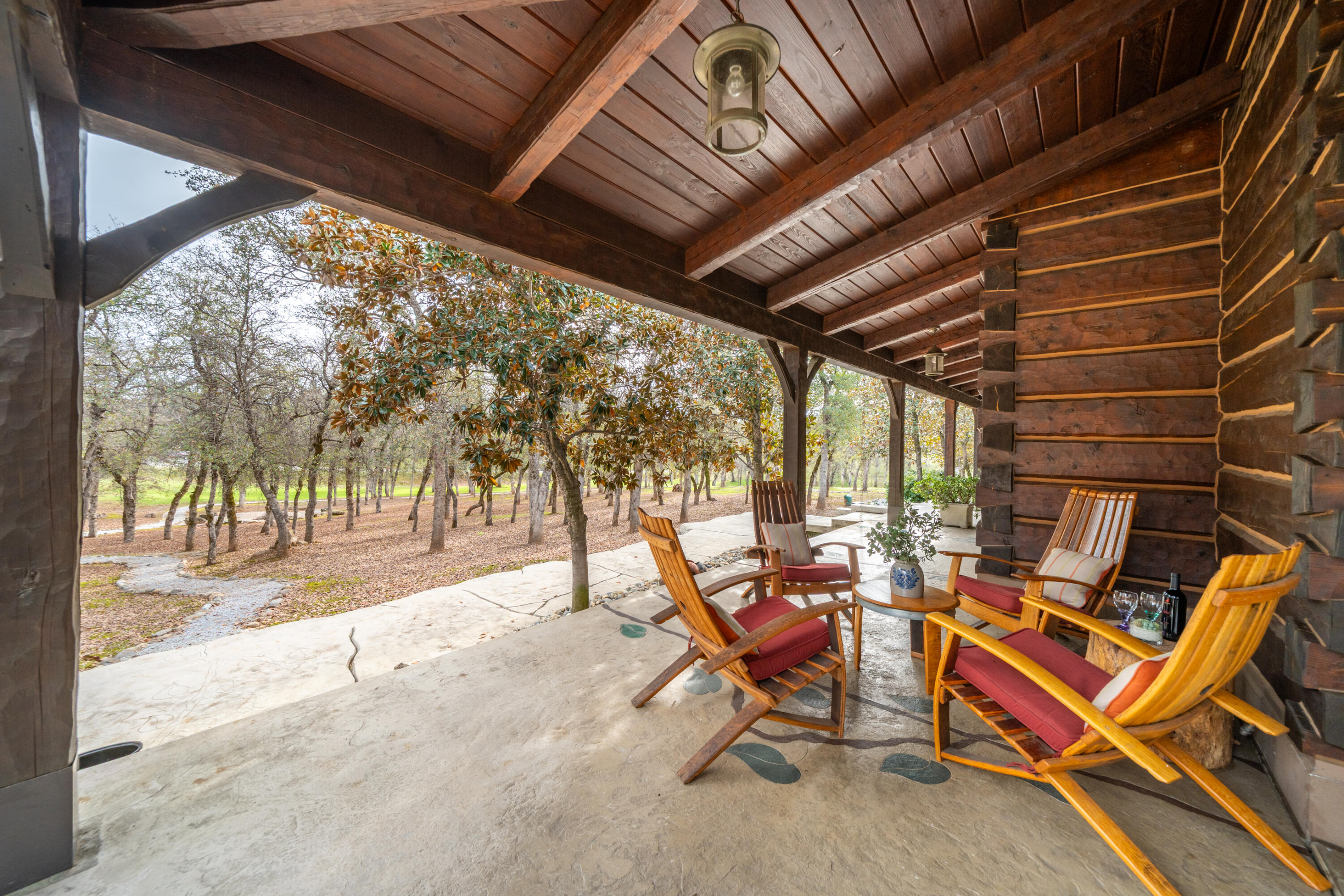 15900 El Camino Robles Road Redding, CA 96001 - Photo 59 of 117 a view of a patio with table and chairs and couches with wooden floor and fence