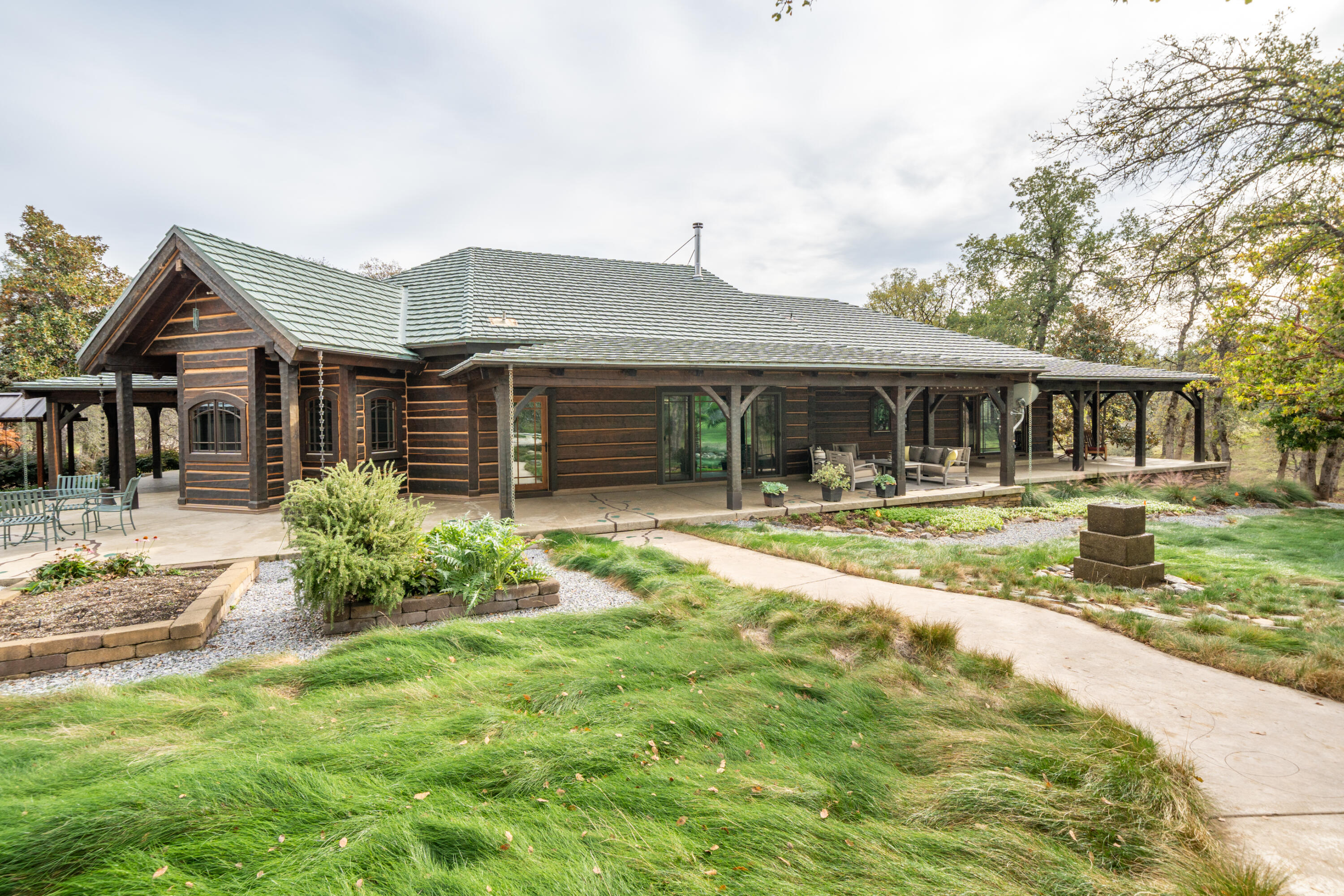 15900 El Camino Robles Road Redding, CA 96001 - Photo 66 of 116 a front view of a house with a yard table and chairs
