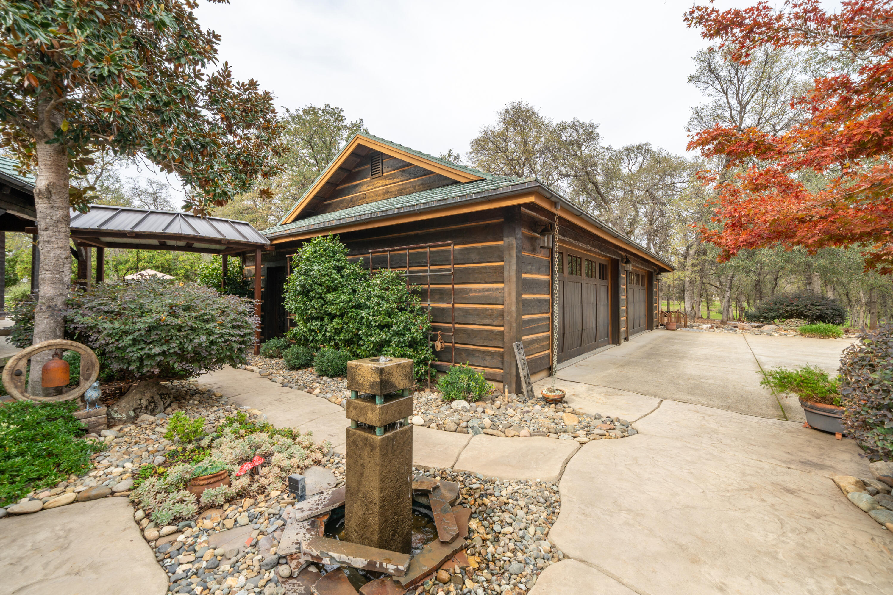15900 El Camino Robles Road Redding, CA 96001 - Photo 8 of 117 a front view of a house with a yard and potted plants