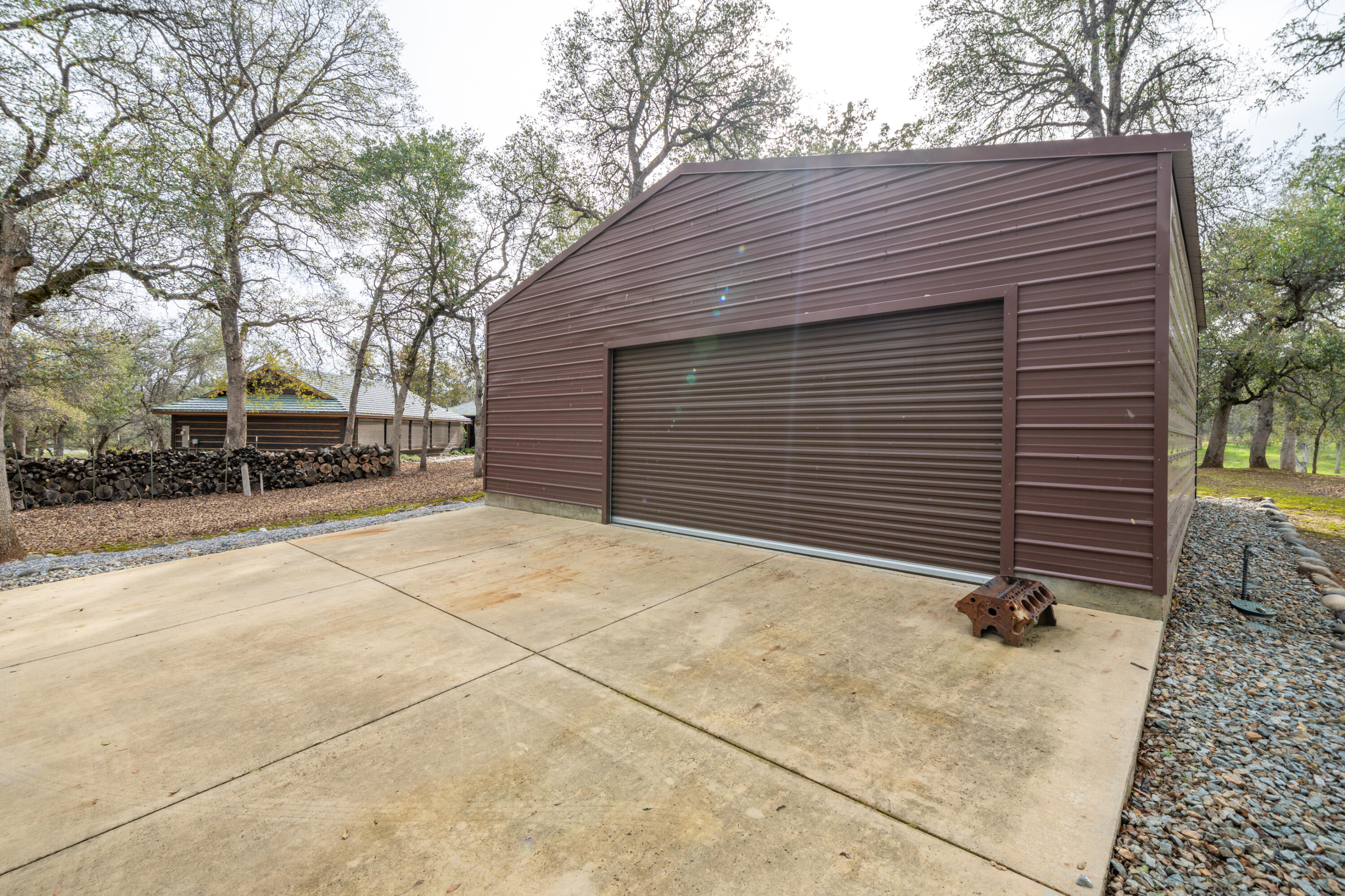 15900 El Camino Robles Road Redding, CA 96001 - Photo 92 of 117 a backyard of a house with a yard and garage