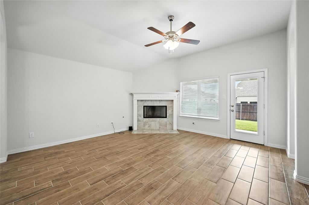 5 Pheasant Run Sanger, TX 76266 - Photo 16 of 27 a view of an empty room with a fireplace and a window