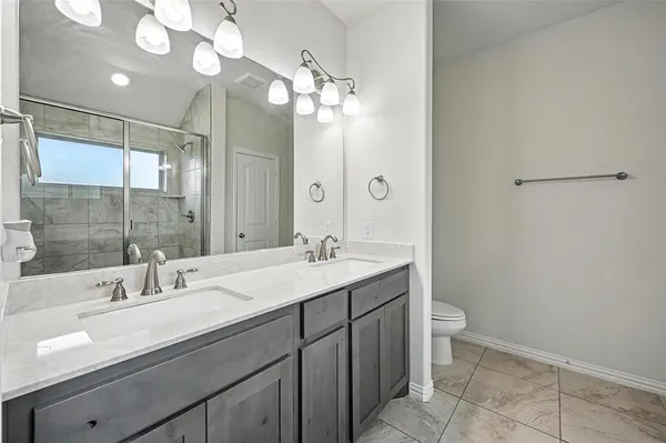 a bathroom with a sink double vanity and a mirror