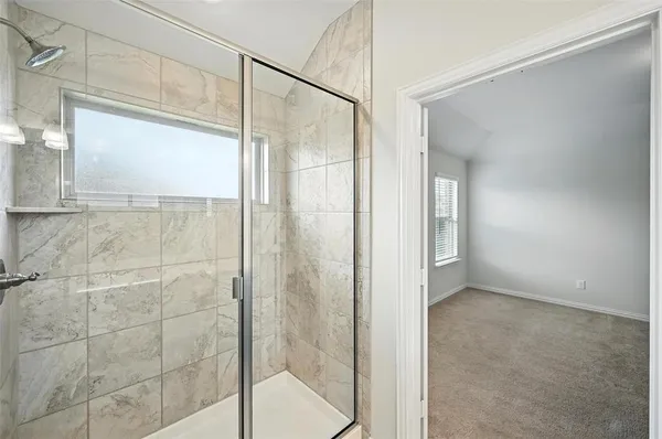 a bathroom with a glass shower door