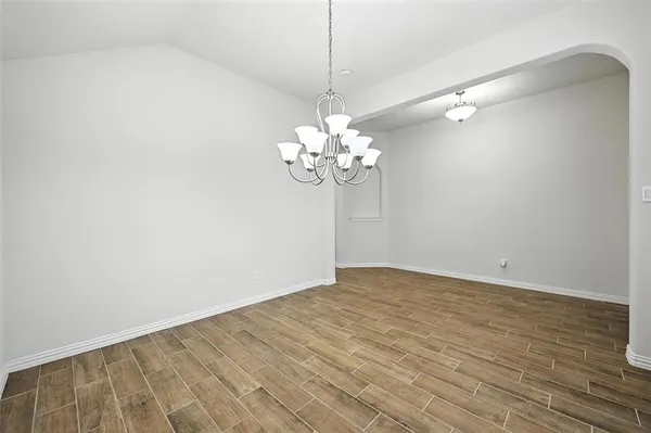 a view of a chandelier fan and wood floor