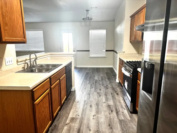 a bathroom with sink shower and a mirror