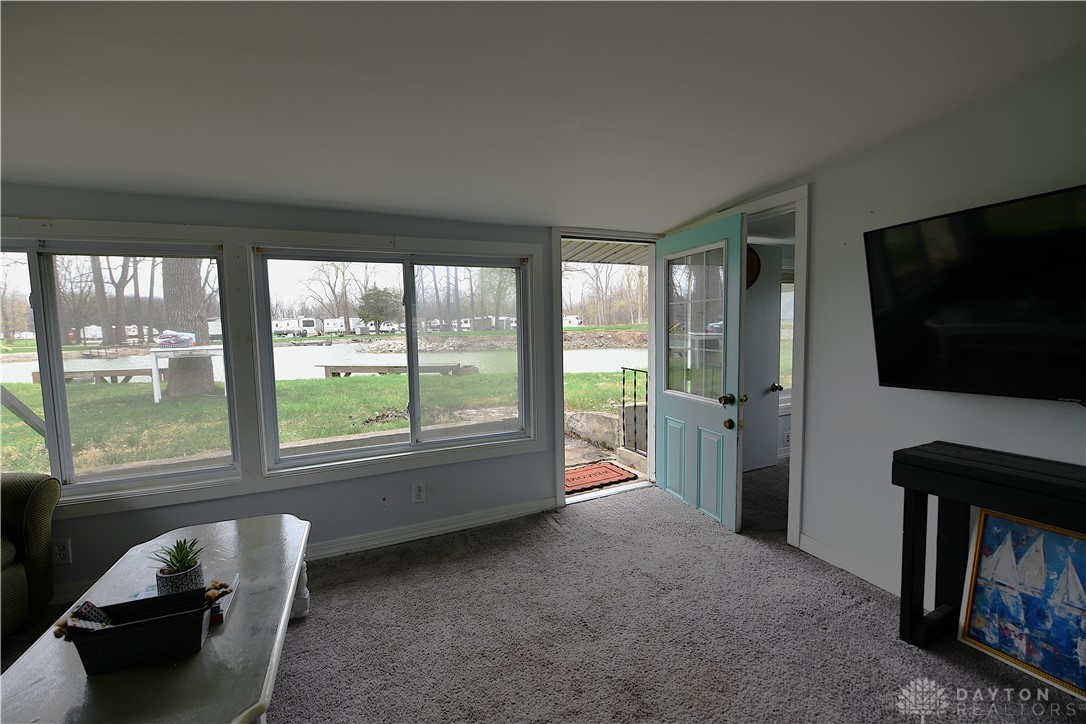 5445 Behm Road, Unit 15 Celina, OH 45822 - Photo 13 of 49 Enjoy water views from this sun-drenched living area, featuring direct outdoor access and ample natural light.