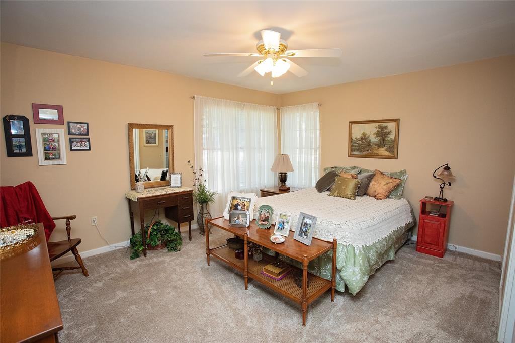 914 Fairview Street Graham, TX 76450 - Photo 10 of 17 a bedroom with a bed and a chandelier