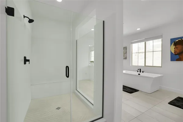 a bathroom with a bathtub and shower