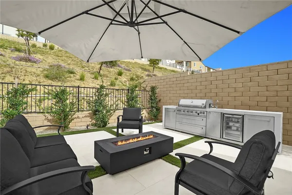 a roof deck with a table and chairs under an umbrella