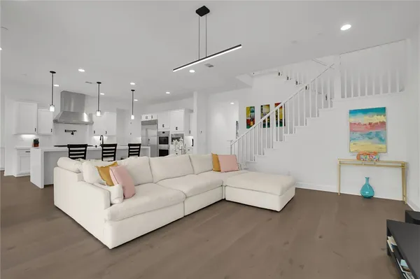 a living room with furniture and kitchen view