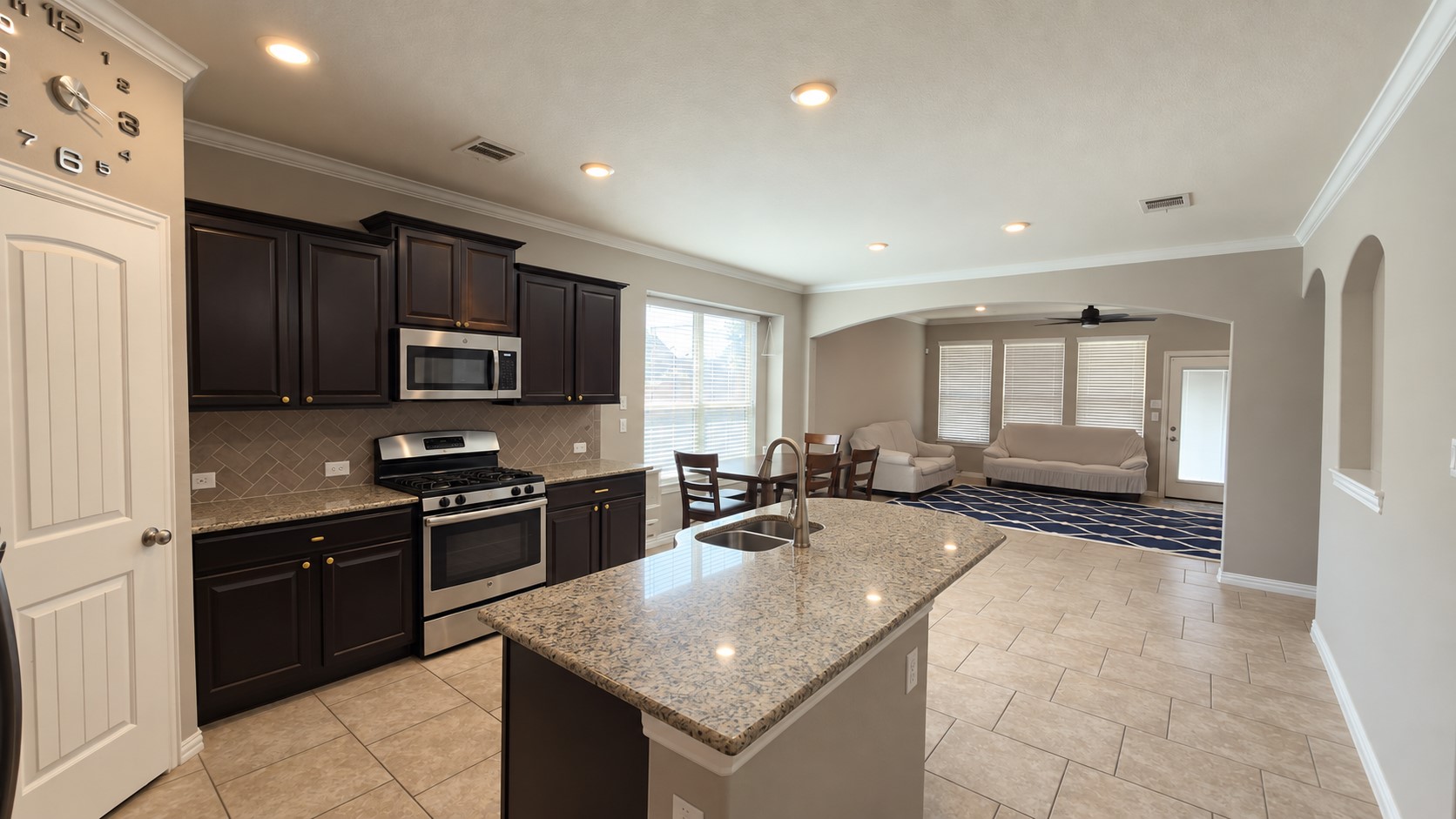 2500 Rough Berry Road Pflugerville, TX 78660 - Photo 10 of 15 Rich wood cabinetry and granite countertops anchor this inviting open-concept kitchen.