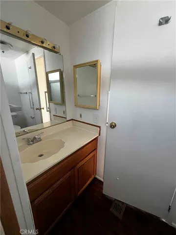 a bathroom with a granite countertop sink a mirror and a vanity