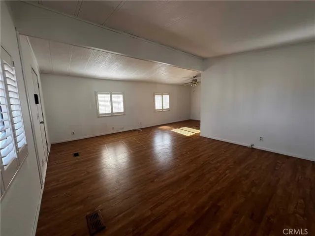 a view of wooden floor and windows in a room