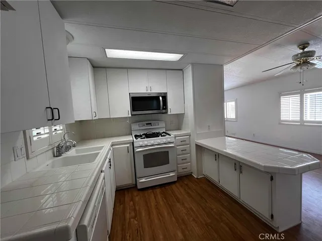 a kitchen with a sink appliances and cabinets