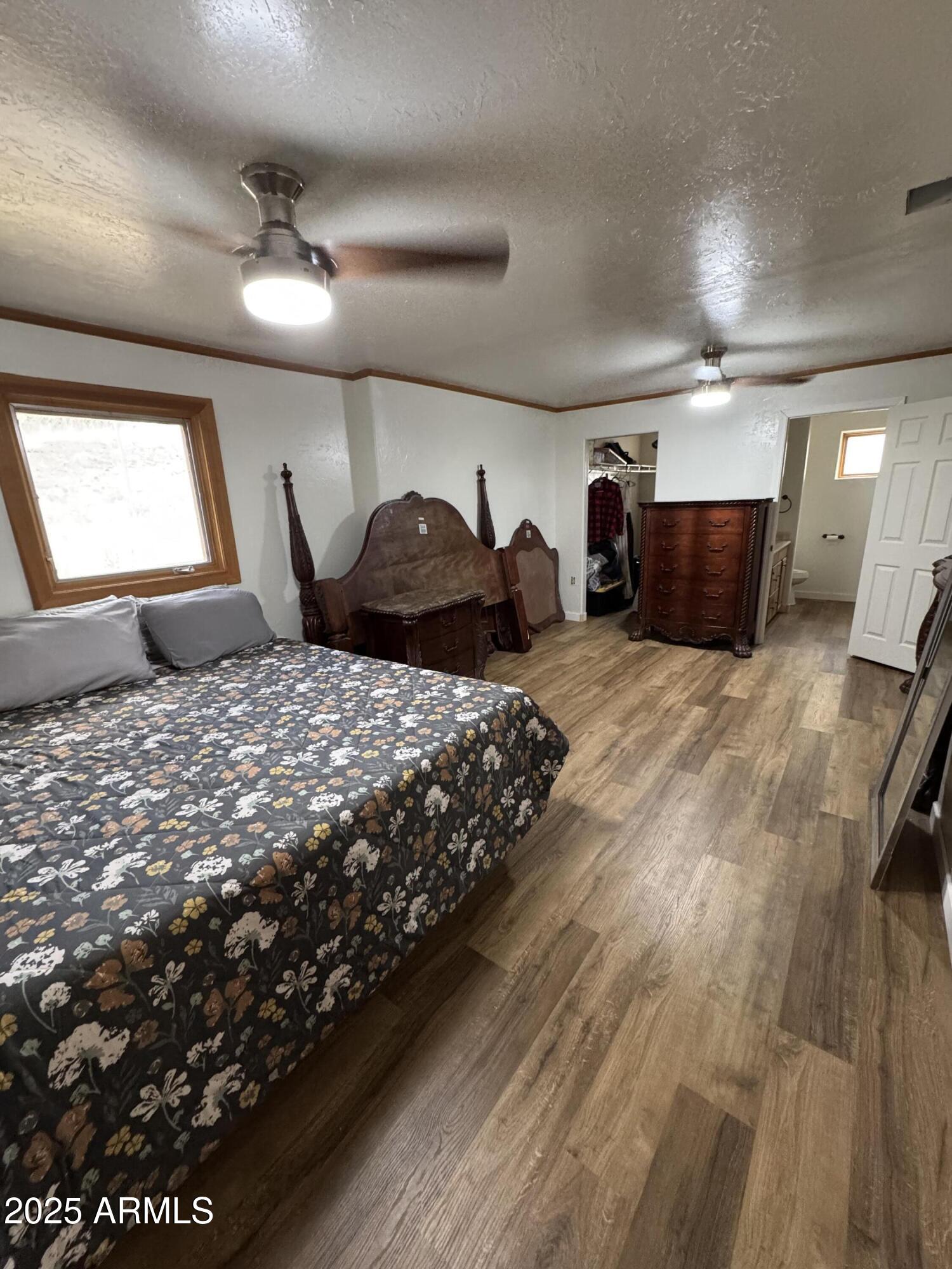 1905 Green Valley Road Heber, AZ 85928 - Photo 11 of 28 a bedroom with a large bed and a chandelier
