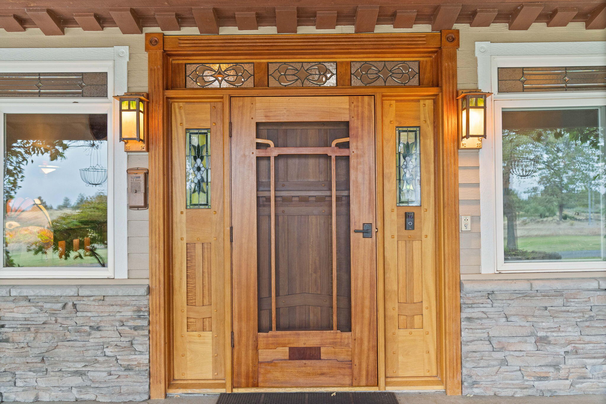 21925 Bear Creek Road Bend, OR 97702 - Photo 88 of 104 Front entryway door is Brazilian cherry w/African mahogany screen doors in the Green & Green style w/handmade stained glass lights